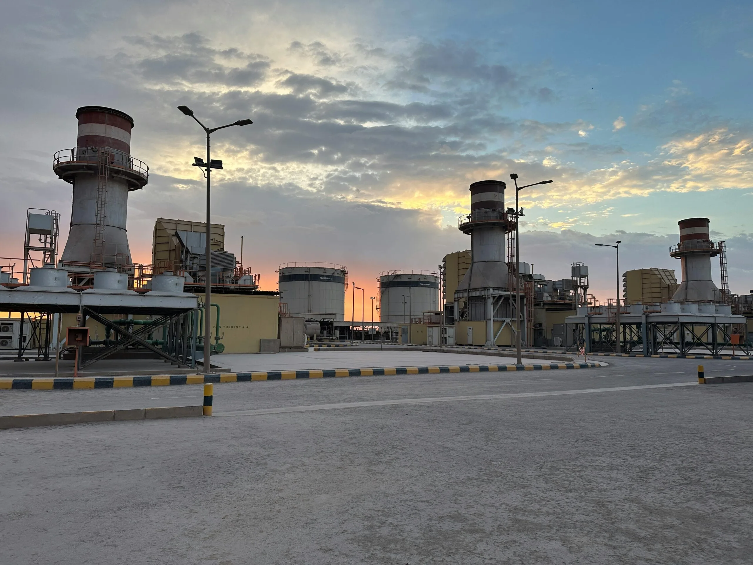 pexels-photo-31277318-31277318 A striking view of an industrial factory during sunrise in Saudi Arabia with a colorful sky.