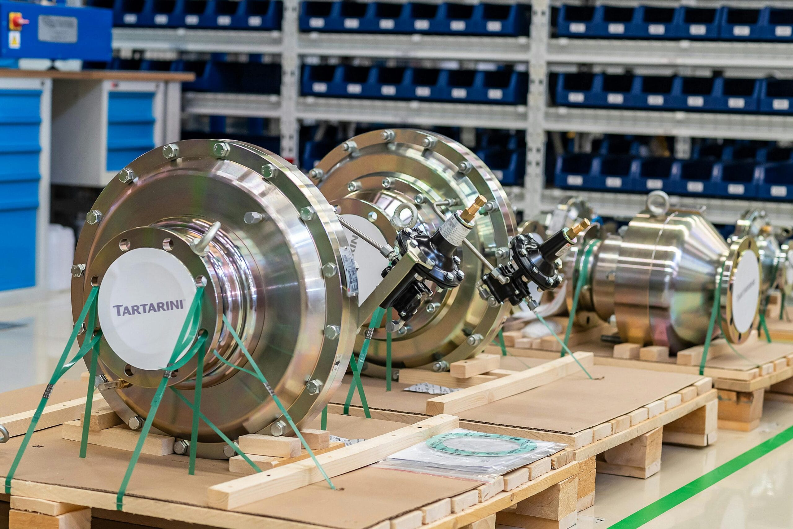 pexels-photo-18540319-18540319 Large industrial valves stored in an organized workshop environment.