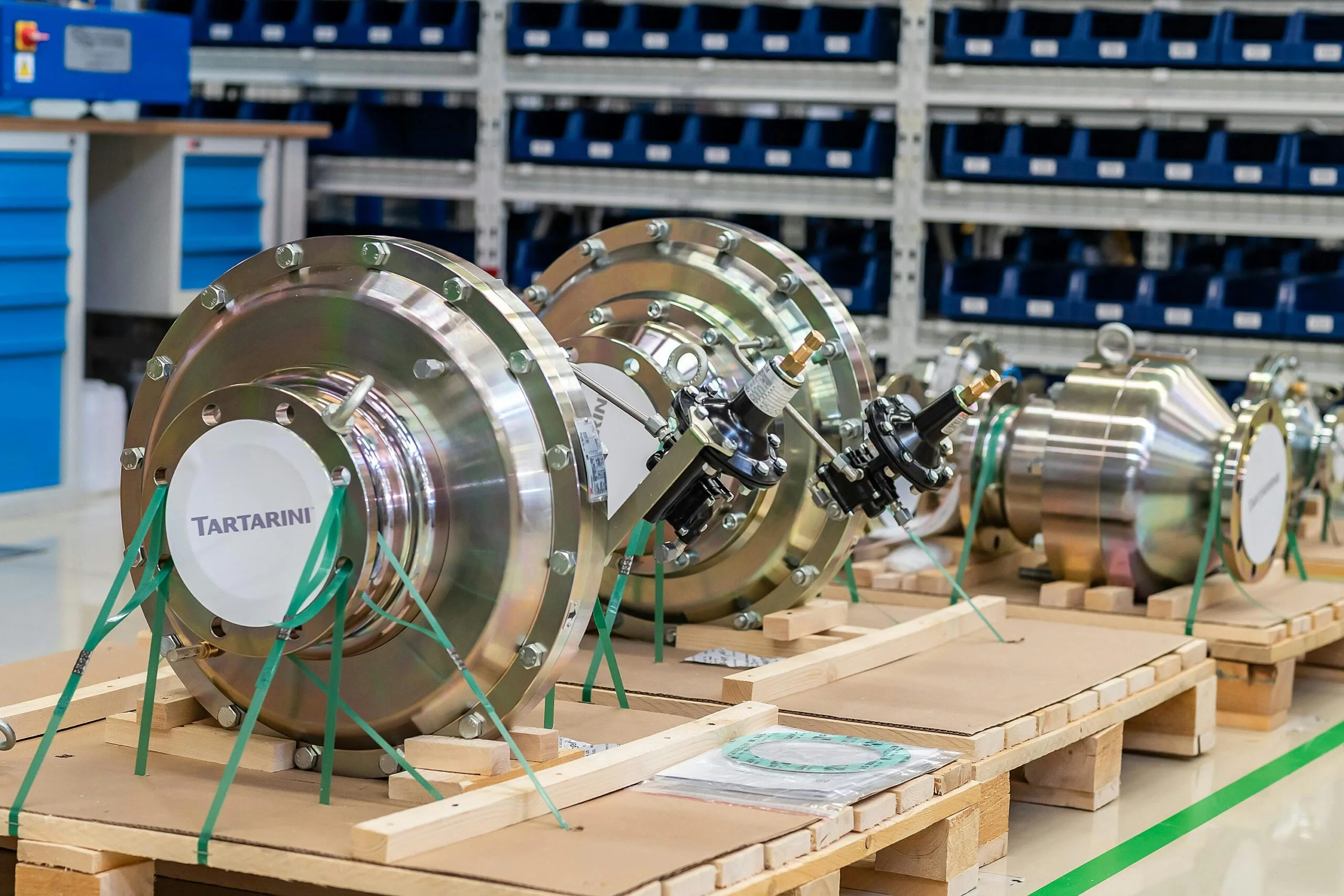 pexels-photo-18540319-18540319 Large industrial valves stored in an organized workshop environment.